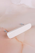Cream ceramic bar handle with its two fixing bolts