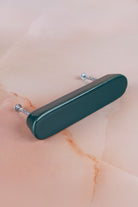Dark teal ceramic bar handle, a deep glossy teal green, with its two fixing bolts