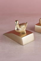 Duck door stopper in polished brass, side view