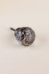 Smokey Grey faceted glass ball cabinet knob with a star cut on the front, on an antique brass finish base with its fixing bolt