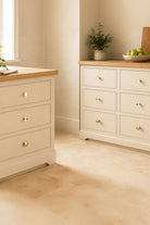 Flat brass cabinet knobs on kitchen cupboards and drawers