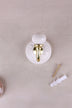 Cream floral ceramic wall hook with a lacquered brass hook