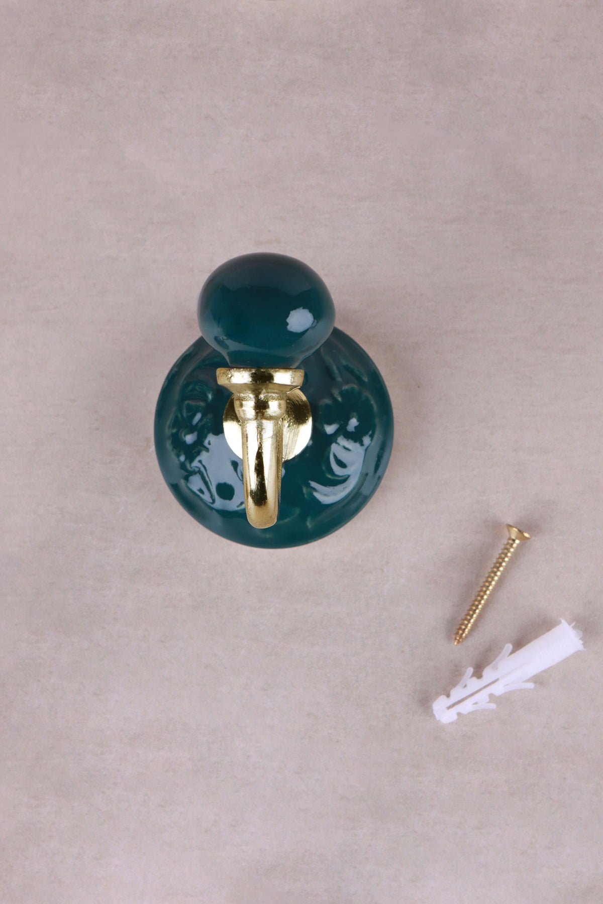 Dark green floral ceramic wall hook with a lacquered brass hook