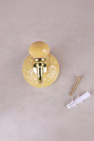 Yellow floral ceramic wall hook with a lacquered brass hook