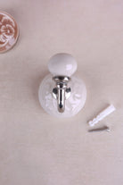 Cream floral ceramic wall hook with a chrome hook