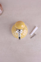 Yellow floral ceramic wall hook with a chrome hook