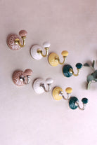 Floral ceramic wall hooks with brass and chrome hooks in four colours