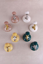 Floral ceramic wall hooks with brass and chrome hooks, third view