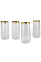 Four gold rim hammered glass tumblers in a row on a white background