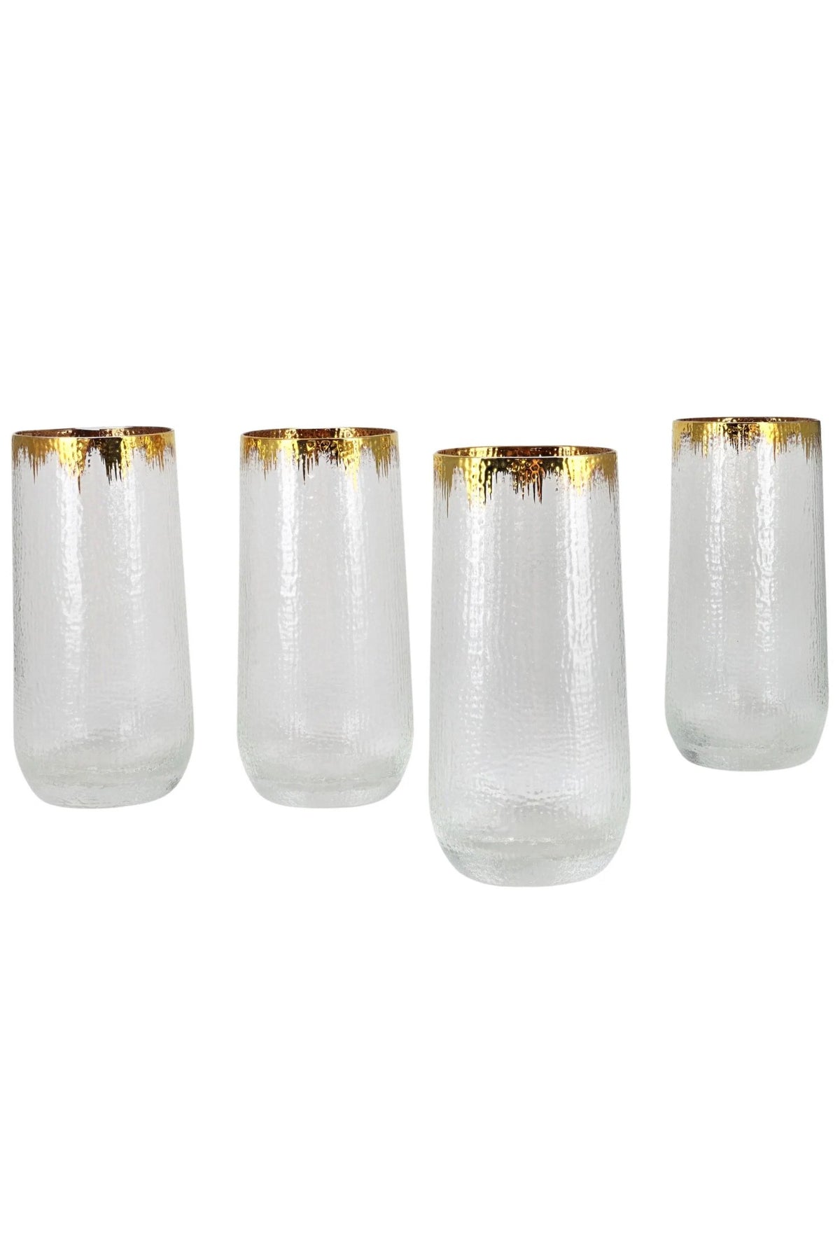 Four gold rim hammered glass tumblers in a row on a white background
