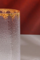 Close-up of the gold splash rim and the hammered texture of the glass