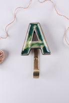 Green ceramic letter hook A with a gold rim