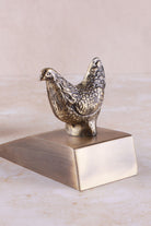 Hen door stopper in antique brass, side view