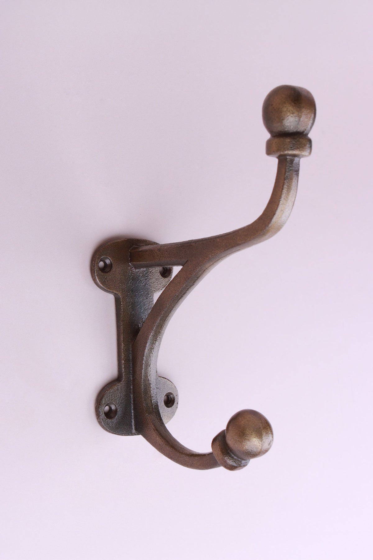 Large Bracket Hook: cast iron large hat and coat hook with a braced top arm and ball ends, on a long back plate with four screw holes, antique brass finish