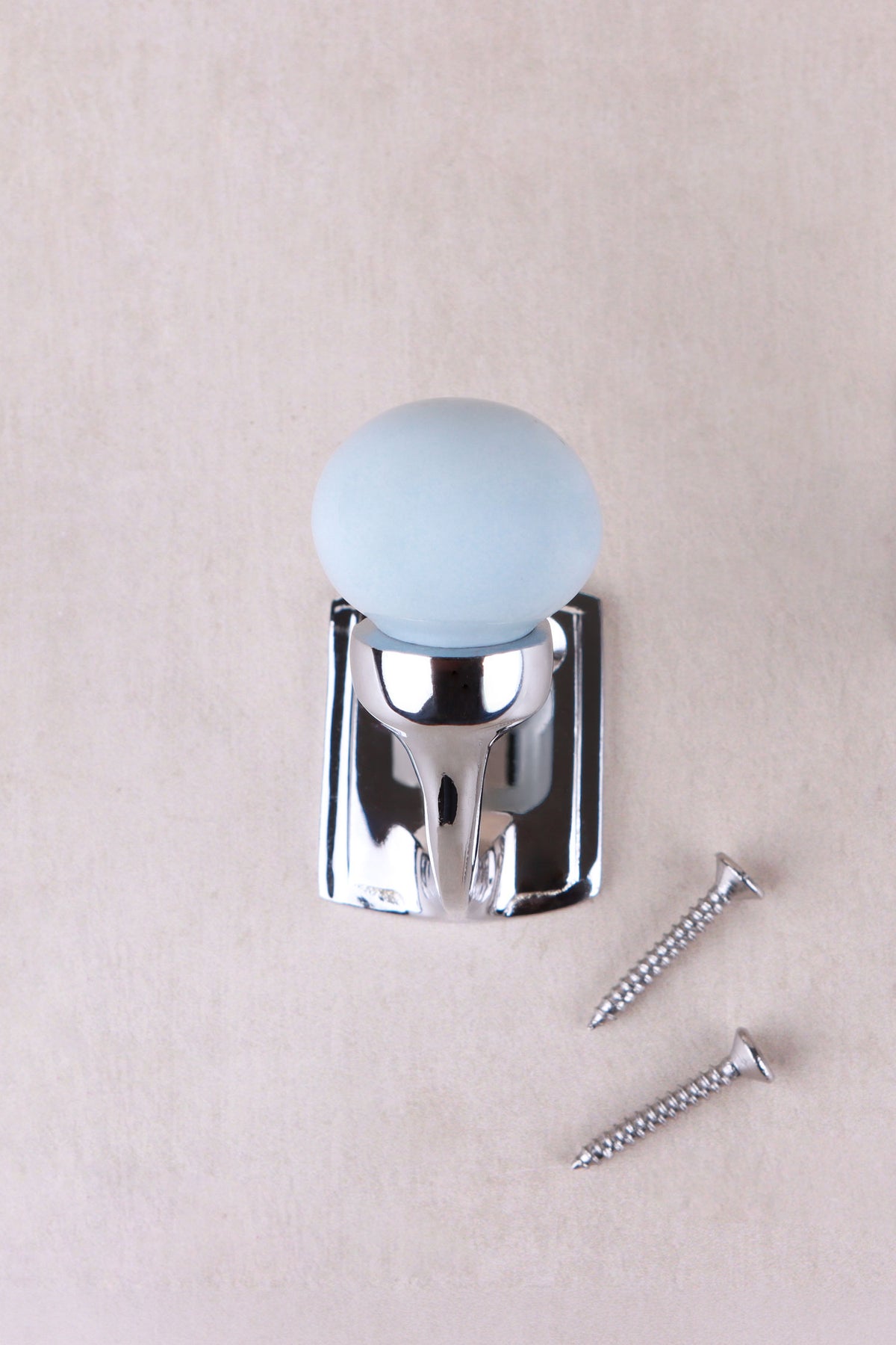 Light grey ceramic ball hook, a very pale grey with a cool blue tint, on a chrome finish hook with its two screws