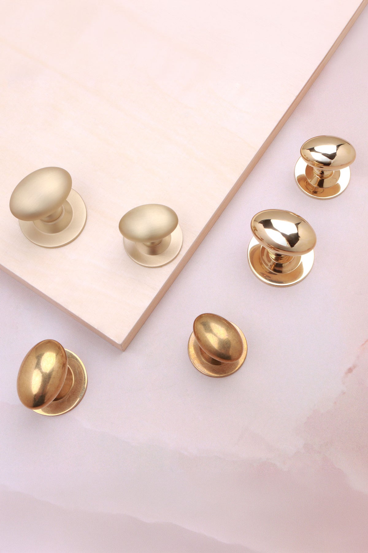 Oval cabinet knob on rose in polished, aged and satin brass, fourth view