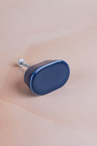 Cobalt blue oval ceramic cabinet knob, a deep glossy blue, with its fixing bolt