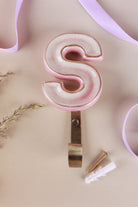 Pink ceramic letter hook S with a gold rim