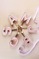 Pink ceramic letter hooks, fourth view