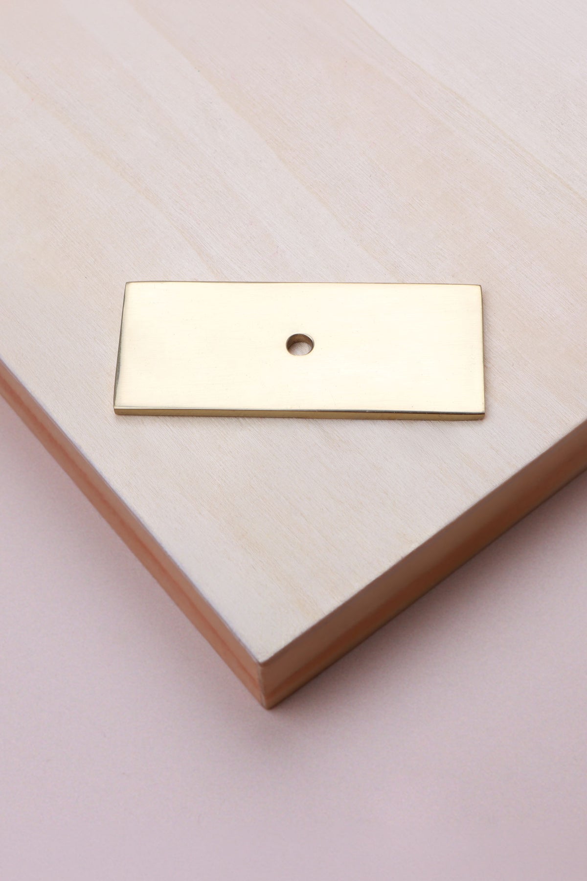 Polished brass rectangle backplate, 60 x 25mm: solid brass with a 4mm centre hole for the knob bolt