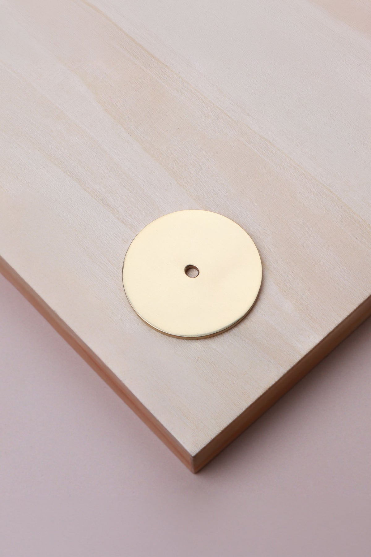 Polished brass round backplate, 45mm across: solid brass with a 4mm centre hole for the knob bolt