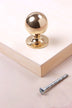 Round cabinet knob in polished brass