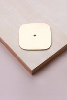 Polished brass squircle backplate, 60 x 60mm with softly rounded sides: solid brass with a 4mm centre hole for the knob bolt