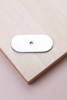 Polished chrome oblong backplate, 54 x 25mm with rounded ends: chrome-plated solid brass with a 4mm centre hole for the knob bolt