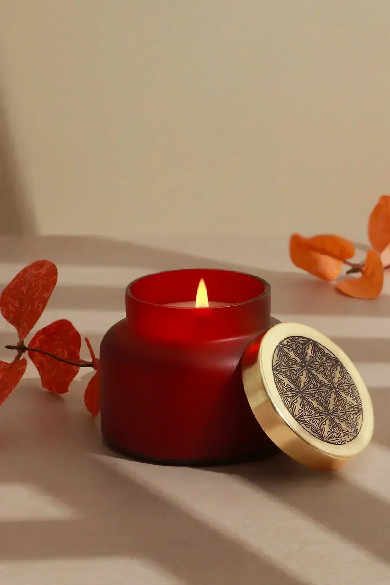 Rasa Ember Sandalwood Scented Candle in Frosted Red Glass — close-up view, G Decor