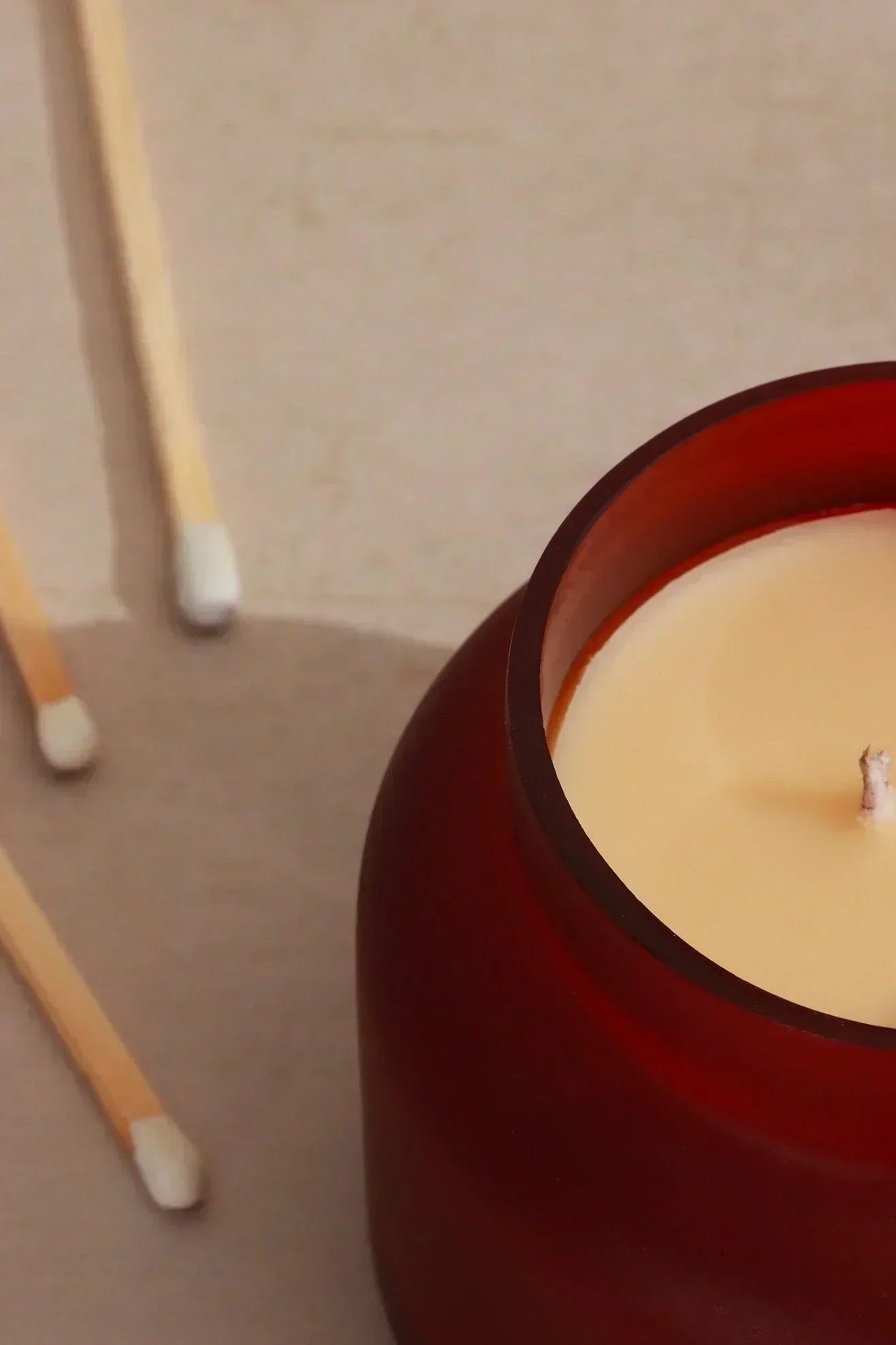 Rasa Ember Sandalwood Scented Candle in Frosted Red Glass — lifestyle view, G Decor