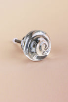 Clear small rose glass cabinet knob, a swirl of glass curling into the centre, on an antique brass finish base