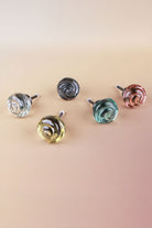 The five colours of the small rose glass cabinet knob side by side: clear, ivory, smokey grey, teal and blush pink