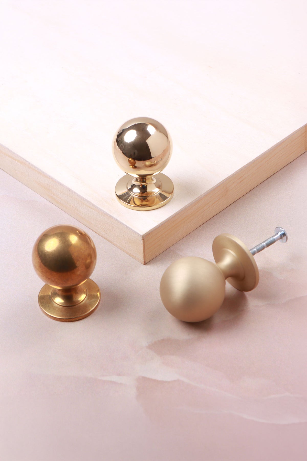 Round cabinet knob in polished, aged and satin brass, second view