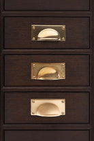Rounded plate cup pull in polished, aged and satin brass