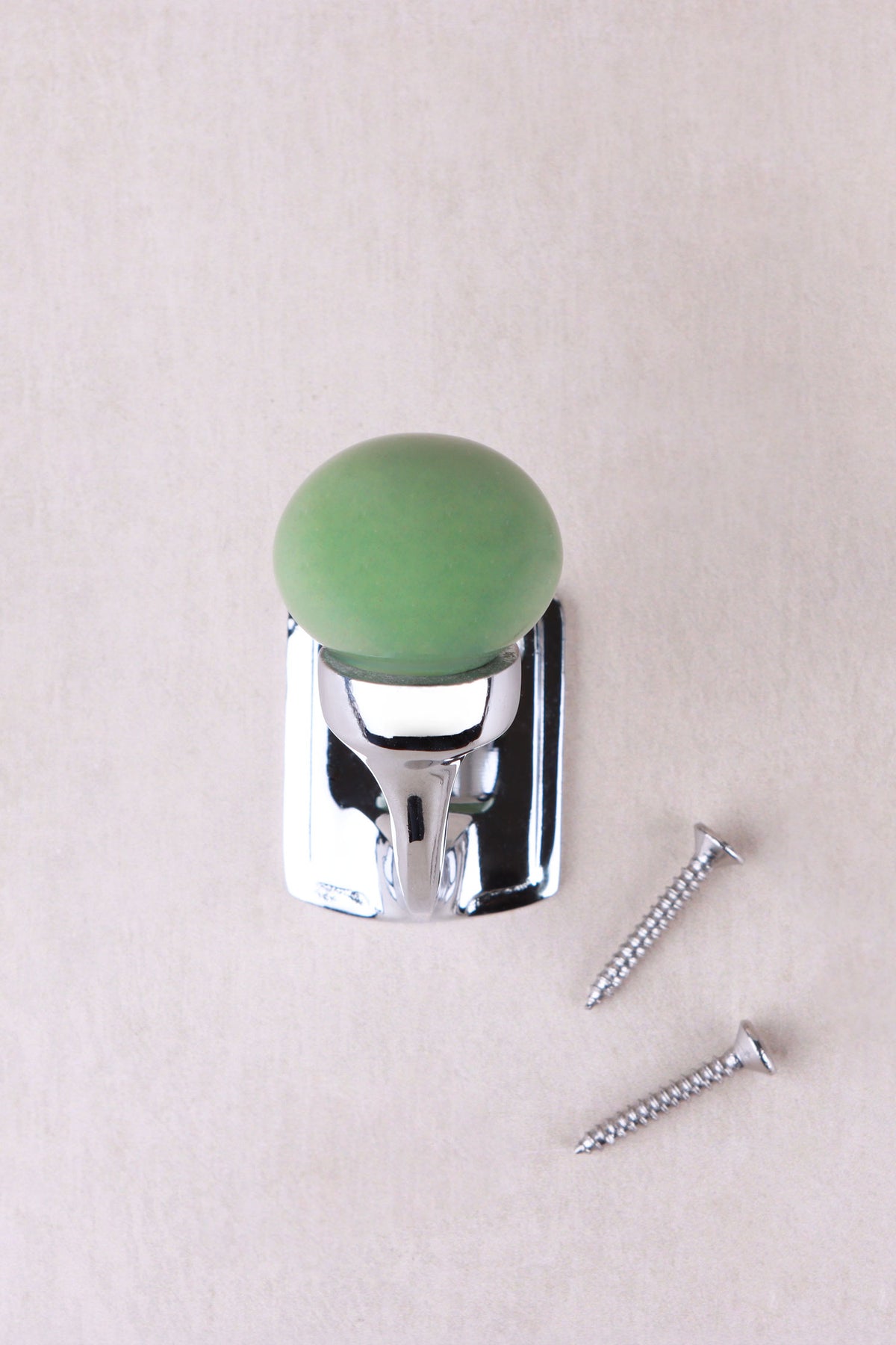 Sage green ceramic ball hook on a chrome finish hook and back plate, with its two chrome finish screws