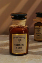 Oriental Gems Elixir Soy Wax Scented Candle in Amber Apothecary Jar — close-up view, G Decor