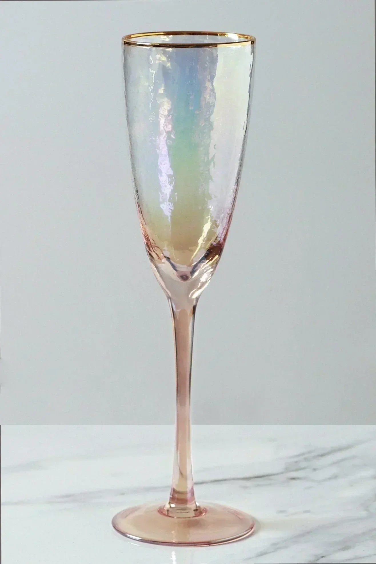Set of four iridescent pearl hammered champagne flutes styled together — G Decor