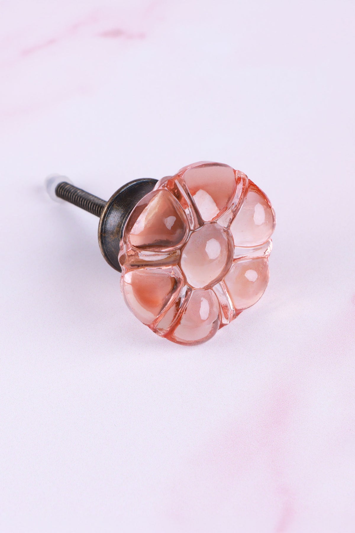 Blush Pink six-petal flower glass cabinet knob, a soft peachy pink, on an antique brass finish base