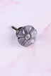 Smokey Grey six-petal flower glass cabinet knob, a cool smoked grey, on an antique brass finish base