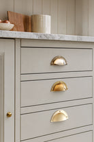 Stepped rim cup pull in polished, aged and satin brass