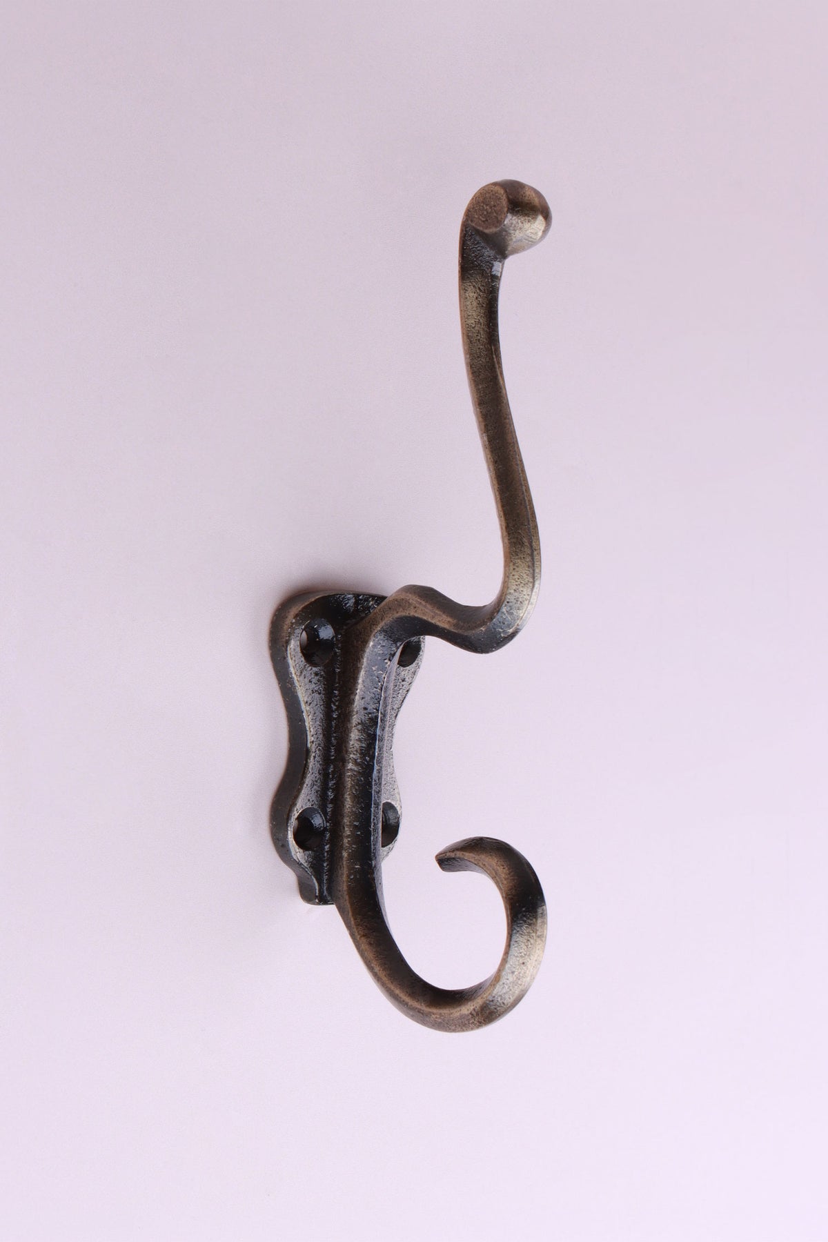 Tall Scroll Hook: cast iron tall S-shaped double hook with scrolled ends, on a long back plate with four screw holes, antique brass finish