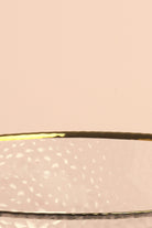 Close-up of the gold rim and hammered texture of the Thalia glass bowl