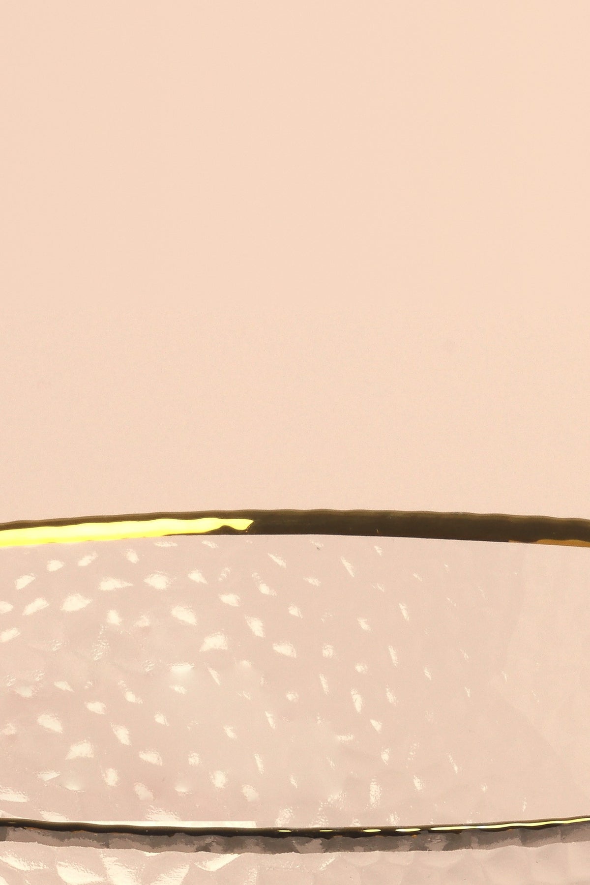 Close-up of the gold rim and hammered texture of the Thalia glass bowl