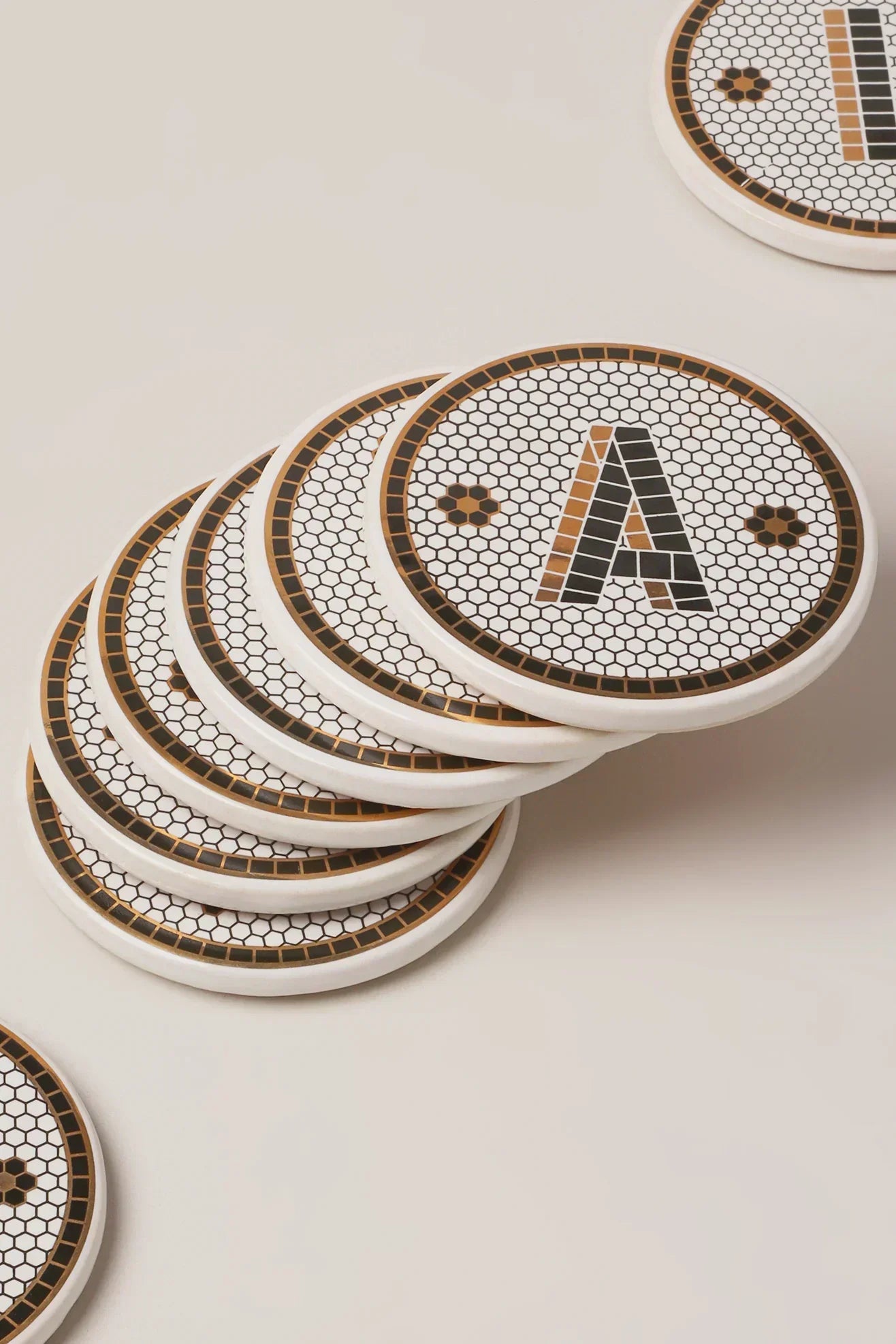 Black and gold pub tile monogram coaster styled in a tablescape — G Decor