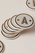 Black and gold pub tile monogram coaster styled in a tablescape — G Decor