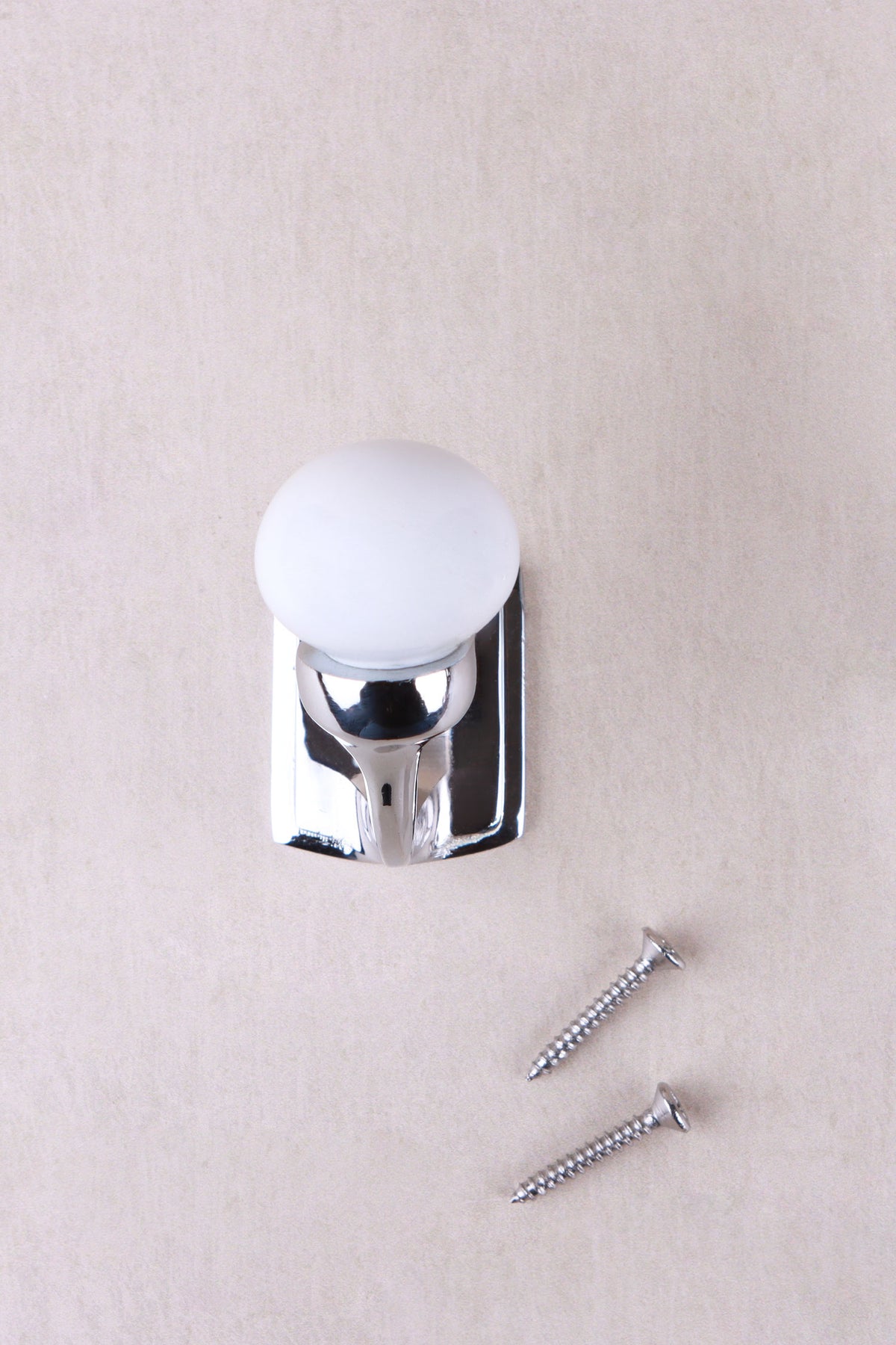 White ceramic ball hook on a chrome finish hook and back plate, with its two chrome finish screws