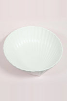 Deep white porcelain shell bowl with fine ridges inside