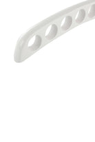 Close-up of the round holes in the white wooden scarf hanger