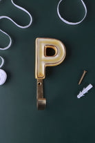 Yellow ceramic letter hook P with a gold rim