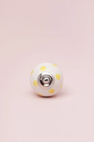 Polka Dot Ceramic Cabinet Knob in Pastel Yellow and Baby Pink — close-up view, G Decor